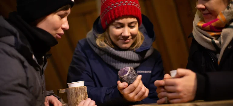 Guided Amethyst Mine tour in Finland with tourists holding crystals
